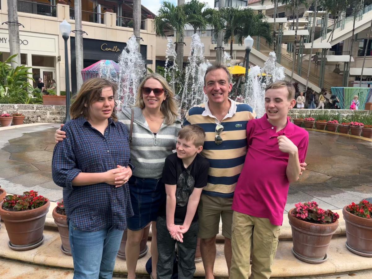 Photo of the Sando family in front of a fountain