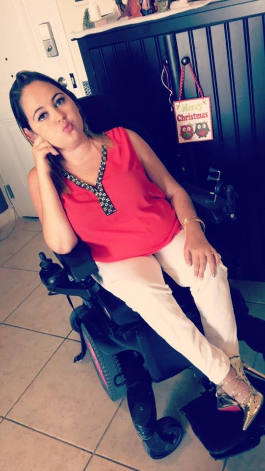 Lorinda in front of a cabinet in her home.