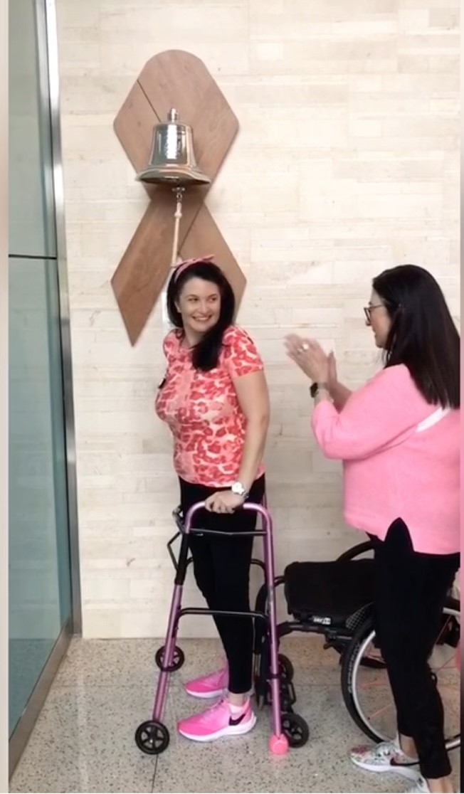 Photo of Justine and Mom standing in front of bell