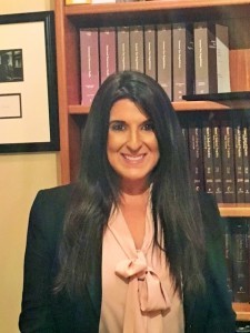 head shot of Lisa standing in front of legal books.