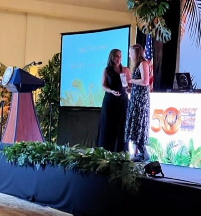 Photo of Debbie Dietz accepting City of Miami award