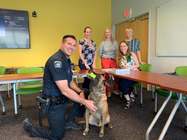 Officer Alex and Roy with the Childrens Trust Team having a meeting about the  k9s for kids project
