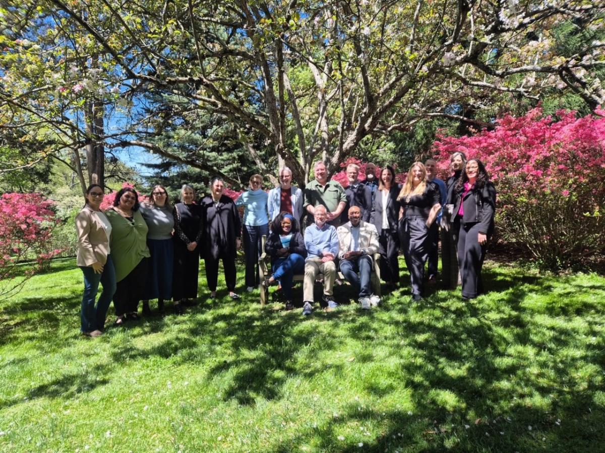 A group stands under a tree 