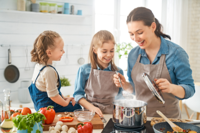 mom and kids cooking dinner