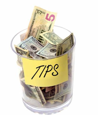 Tip Jar stuffed with money. Isolated on white with room for your text. Tip jar with sign. charity jar 