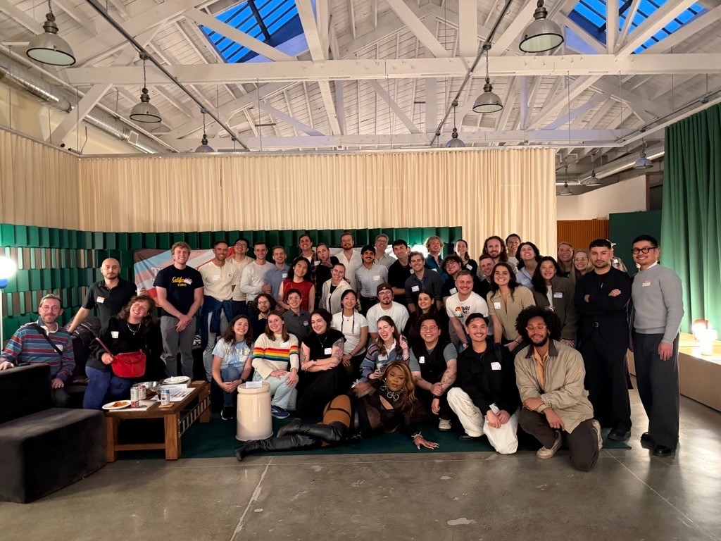 The SE3 committee poses for a photo in a room during Harvey Milk Day Happy Hour.
