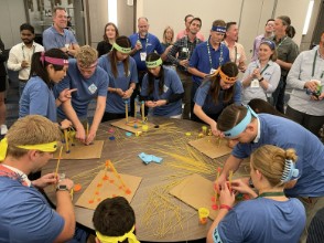 A photo of SEAONC members dressed in blue shirts around a table.