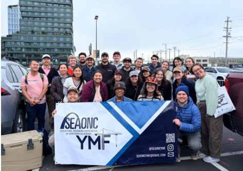 YMF members pose around a banner during a Giants game in June.