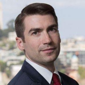 A headshot of David Ojala wearing a suit.