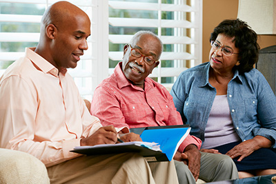 lawyer discussing planned giving with a couple at their home