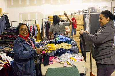 A photo of two City of Winston-Salem employees joyfully folding clothes during their MLK Day of Service Helping Hands Day