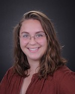 Nichole Ciccarelli headshot, woman with brown, mid-length hair and glasses, smiling