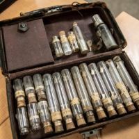 Old medical kit bag filled with vials