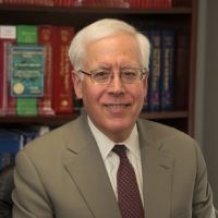 David Edelstein, MD, white haired man with glasses, wearing a suit