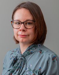 Brunette woman with glasses smiling
