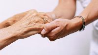 Two people holding hands