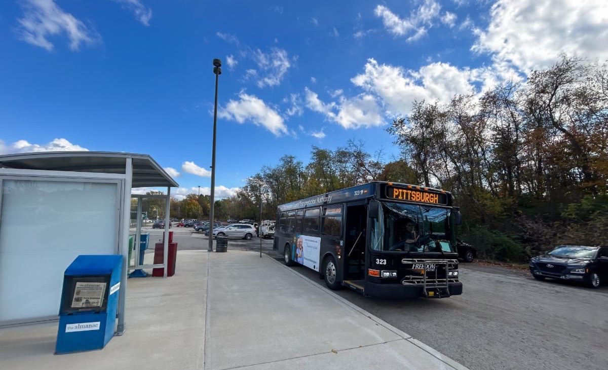 Bus at stop on sunny day