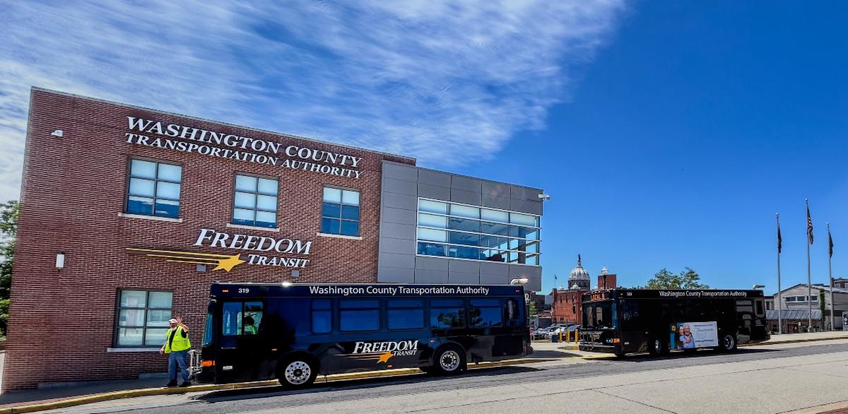 Bus parked at transit center on a sunny day