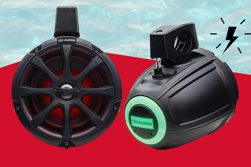 photo of a pair of MCA 106b Marine Cans showing front of grill with led lights and slanted right back view of logo and led light with active icon
