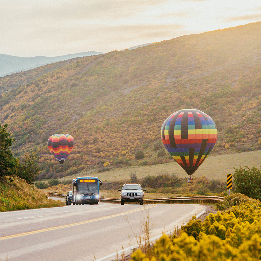scenic view of a RFTA bus driving at sunrise during the Snowmass Hot Air Balloon Festival