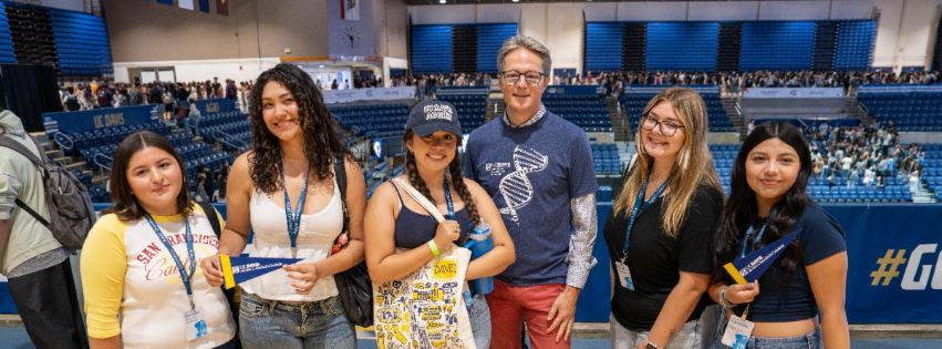 A group of students pose with Dean Chédin during Fall 2026 Orientation events.