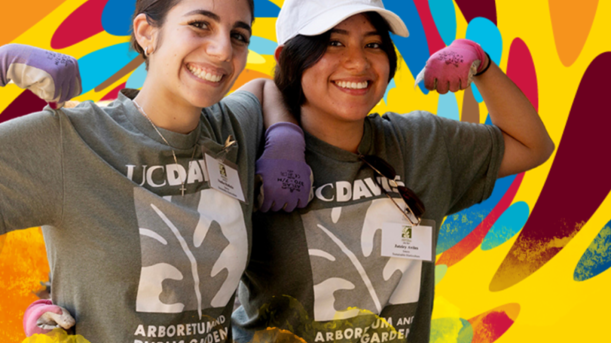 Image of two UC Davis students smiling and flexing their arms in triumph for the camera.