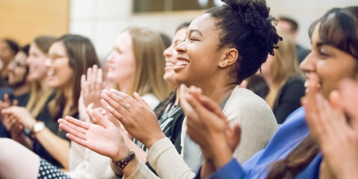 Large group of people clapping