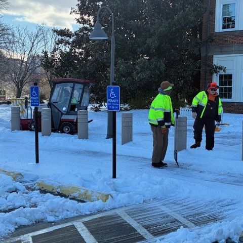 County crews clearing snow outside county office building in 2026