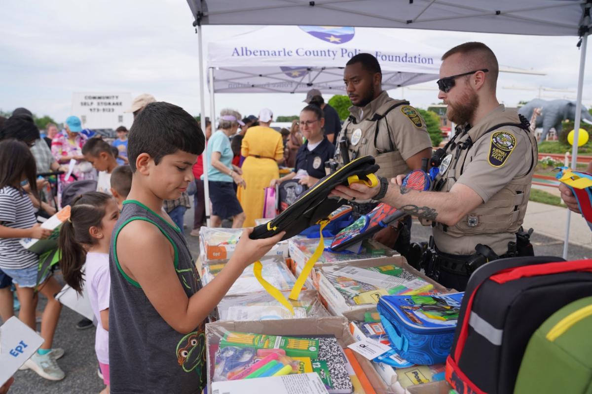 NNO - 2026 - Children receiving school supplies from ACPD officers
