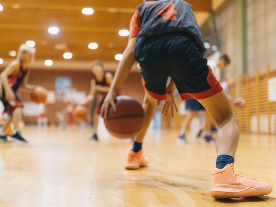 A man dribbles a basketball