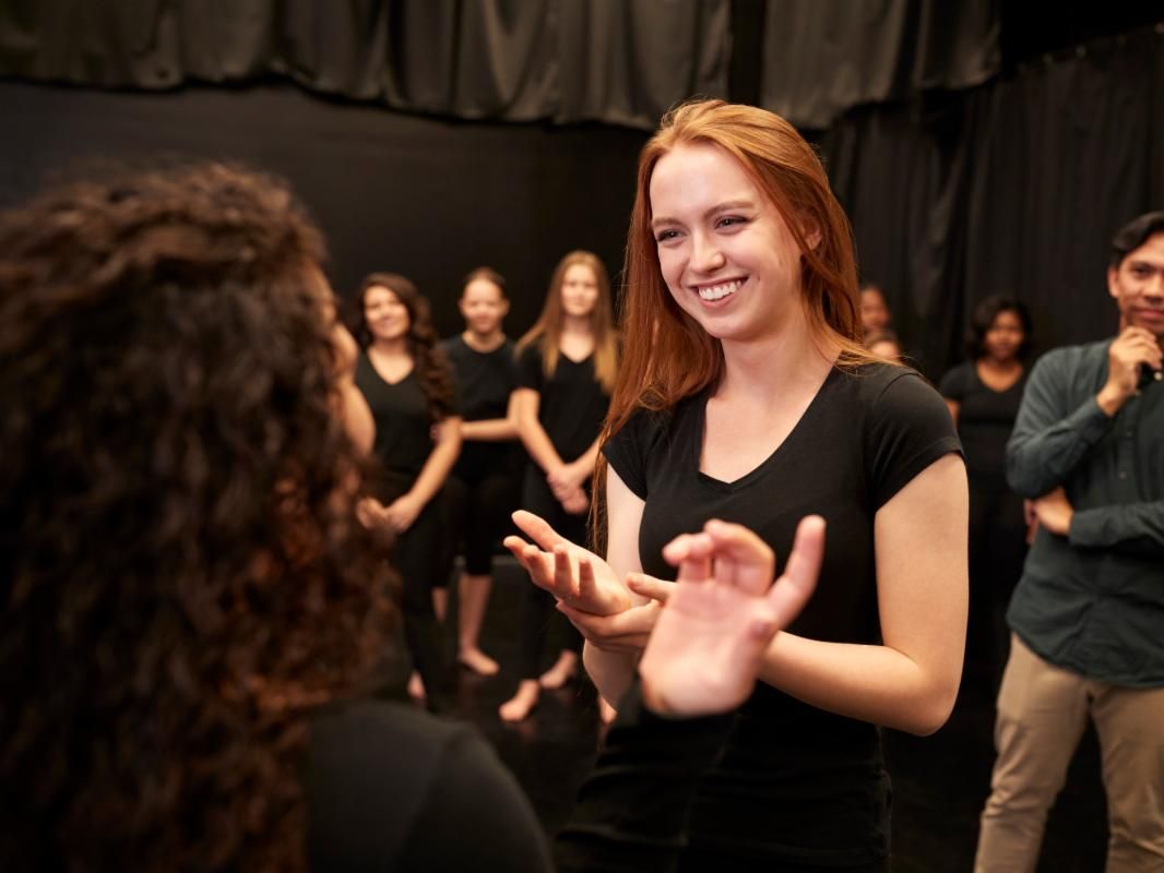 Two women perform improv