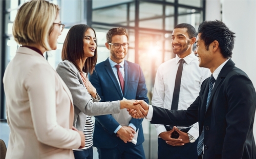 Group_ business people and shaking hands for welcome_ introduction or meeting in office. Handshake_ smile and team with deal for collaboration_ agreement or thank you for b2b partnership opportunity