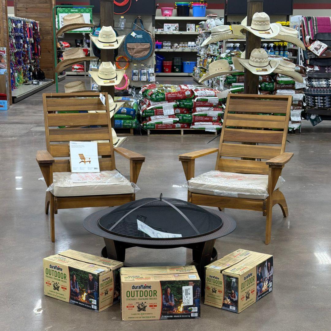 Two outdoor chairs with a fire pit and fire wood