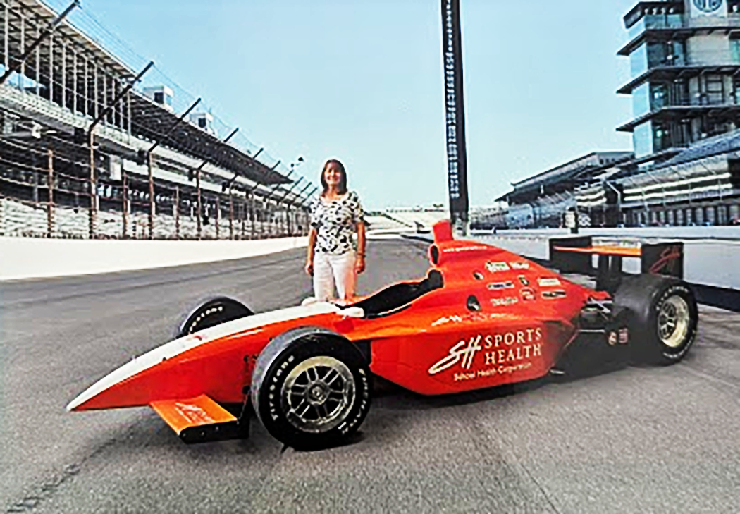 Chris Rouze stands by a race care