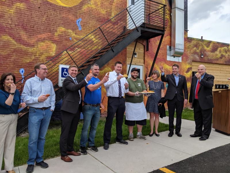 Syracuse Mayor Walsh and Home HeadQuarters CEO Kerry Quaglia among others, help celebrate the Lasher Hardware restoration with an empanada and taco toast compliments of Ponchito's, a local taqueria that is moving into the first level of the building.