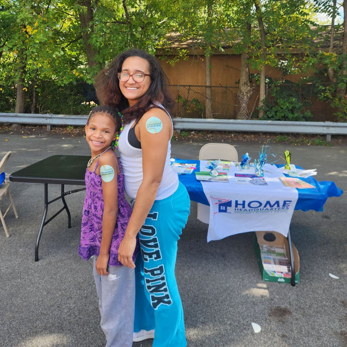 Mom and daughter sporting matching Get Ahead of Lead Stickers on their arms