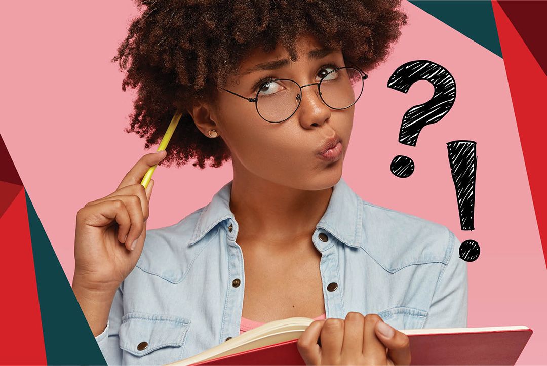 Girl wearing glasses with a confused look on her face holding an open book and and a pencil to the side of her head. A question mark and Exclamation point are at the side of her shoulder.