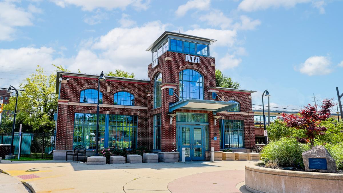 Image of the West 117th Madison RTA Rapid Station a brick building with large arched windows and a windowed tower in the middle