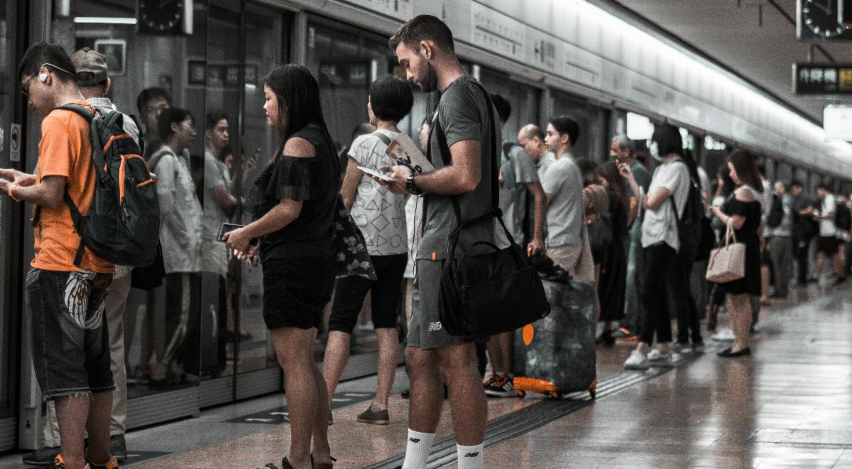 a group of people waiting for a train