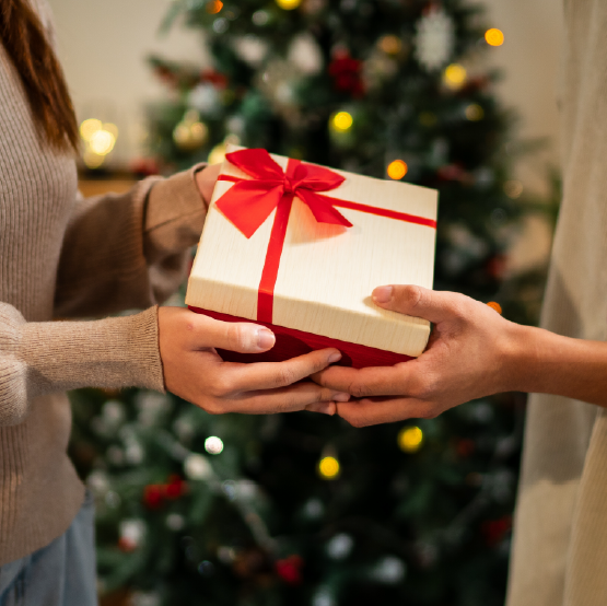 Two people exchanging a Christmas gift