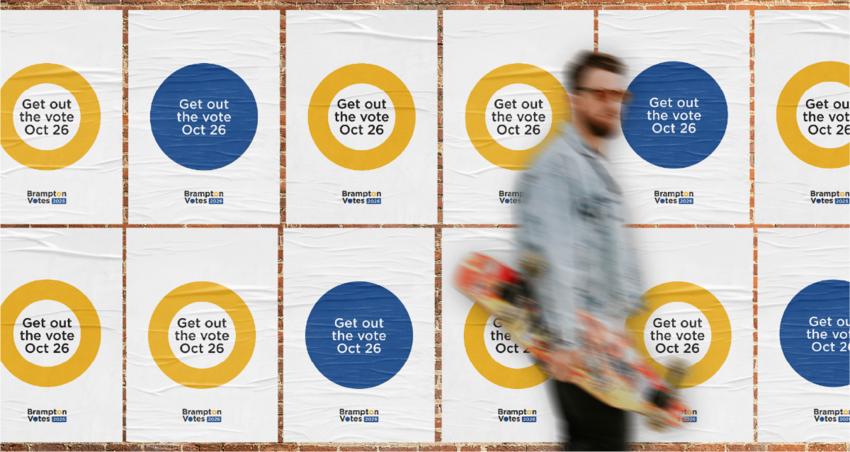 Wall covered with Brampton Votes 2026 posters reading “Get out the vote Oct 26,” with a blurred person carrying a skateboard walking past in the foreground.