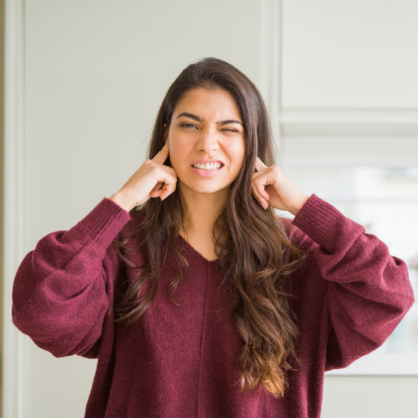 Women plugging her ears
