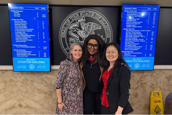 Bill Sponsor Michelle Mussman of the Illinois House with Mariel Hamer-Sinclair and Taneka Jennings of IGAC.  Three women in the Illinois Capitol.