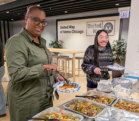 United Way staff serving themselves plates of Mexican food