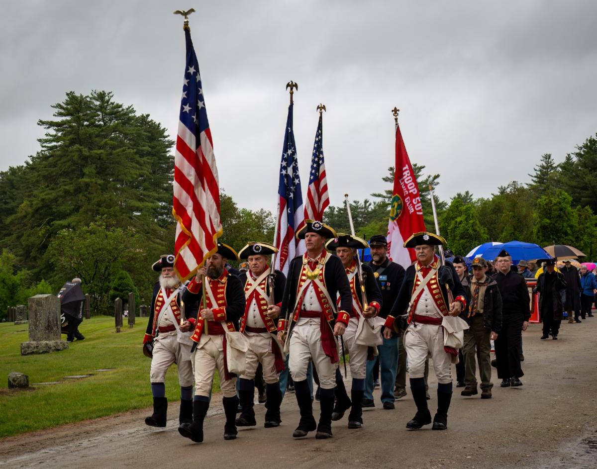 Photo of men dressed in Revolutionary War costume marching at Quabbin Park Memorial Day Ceremony