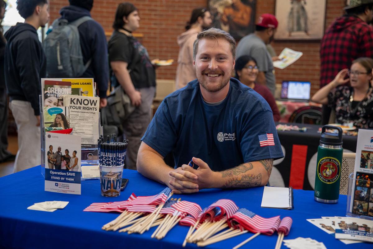 A Chemeketa Community College Peer Advisor at a table during the Student Resource Fair.