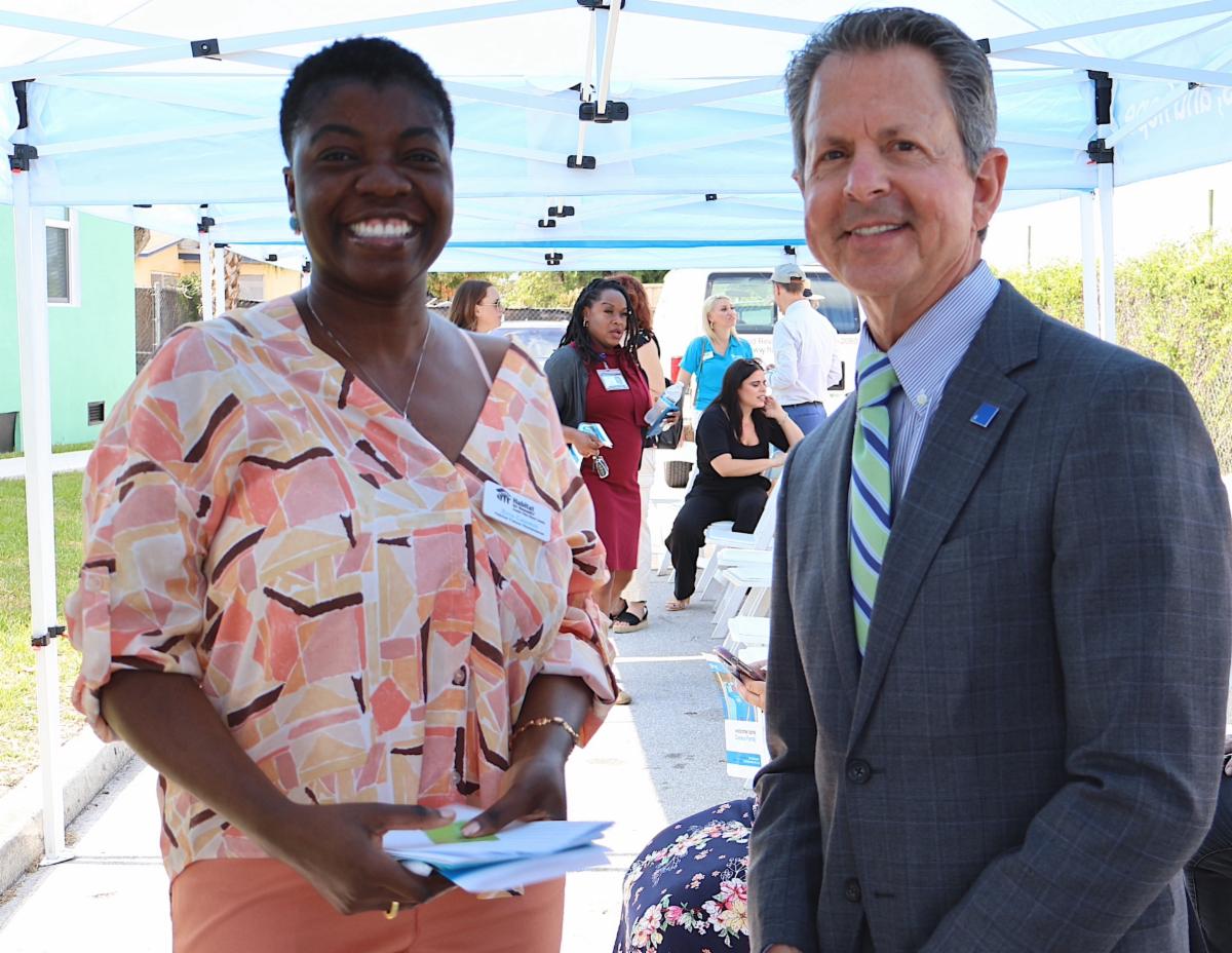 photo of new homeowner Erna Casseus and county commissioner gregg weiss