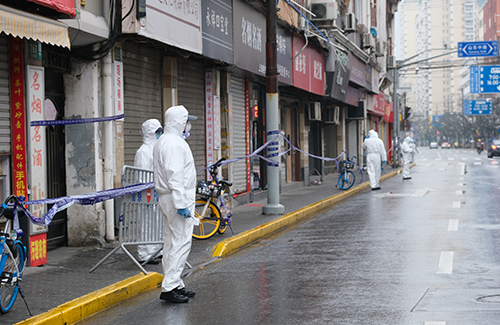 Chinese medical staff in white hazmat suits