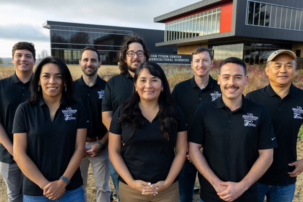 Group photo of people wearing matching soybean breeding program polo shirts
