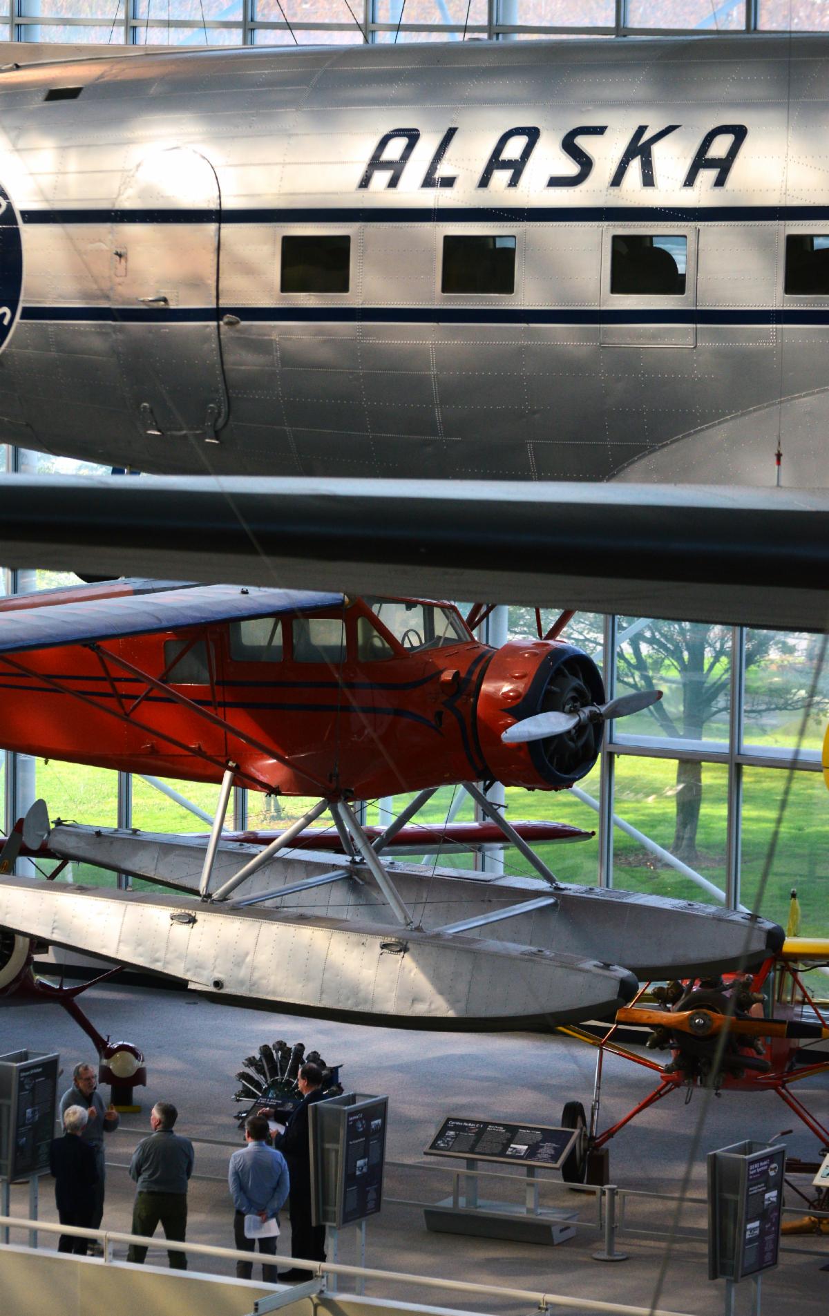 Attendees exploring the Museum of Flight exhibit floor among the aircraft